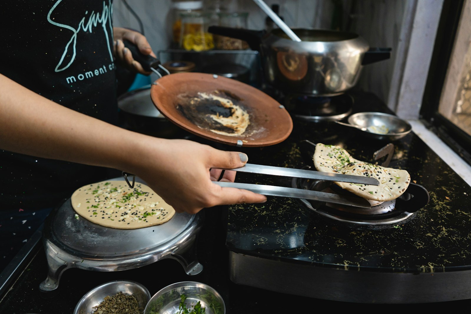 A cook at work, the first hire to weigh when asking how many staff does a small hotel need