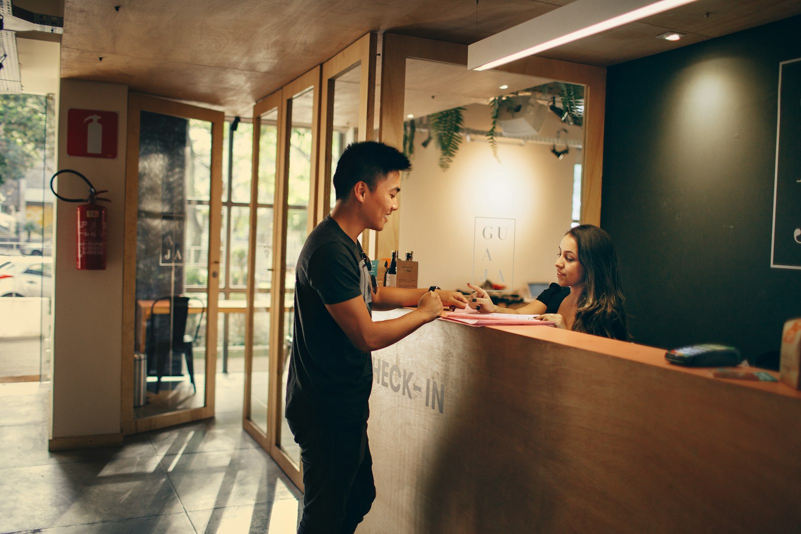 Hotel staff member at the front desk counter during guest checkout billing