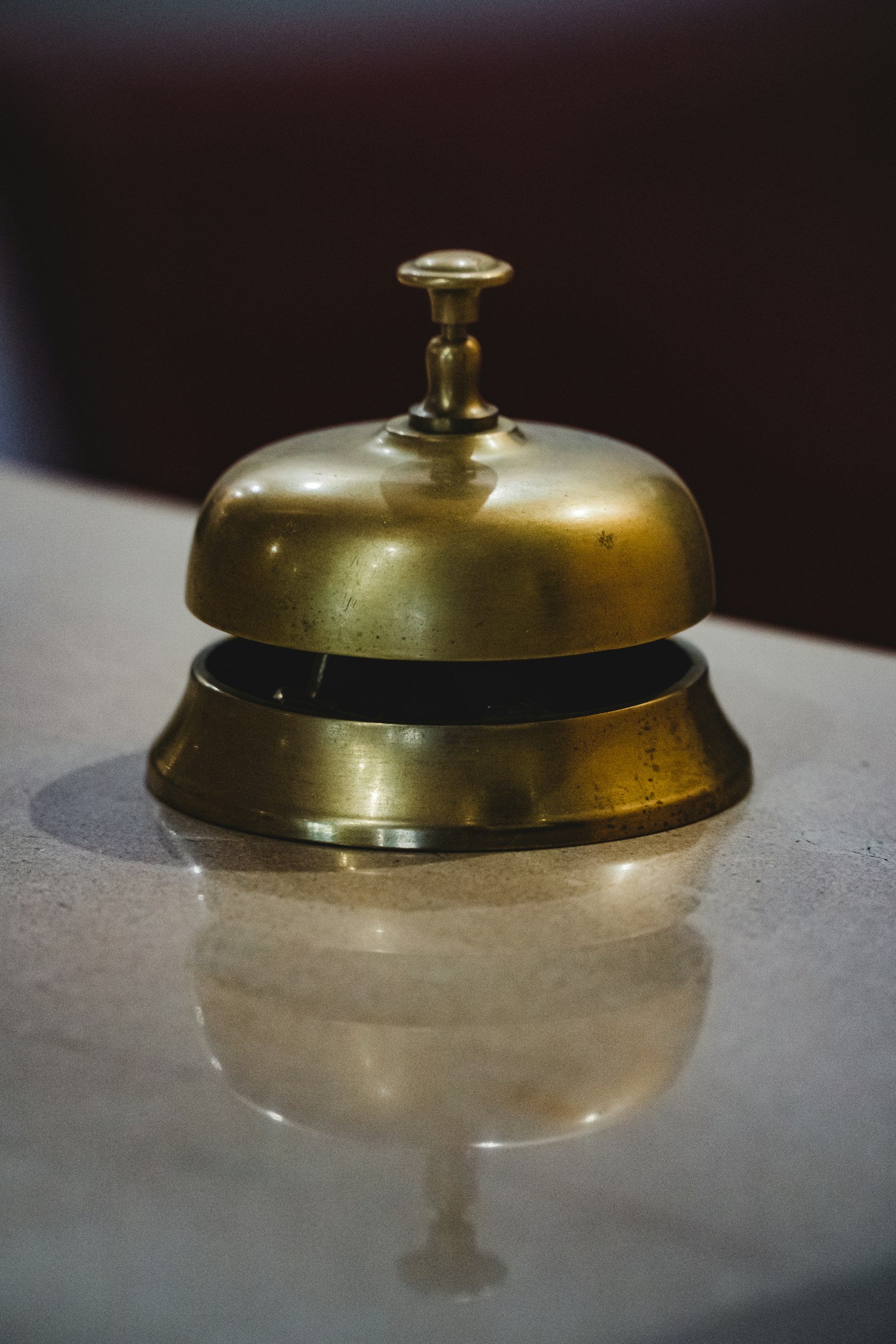 A reception bell waiting for a guest who may not arrive