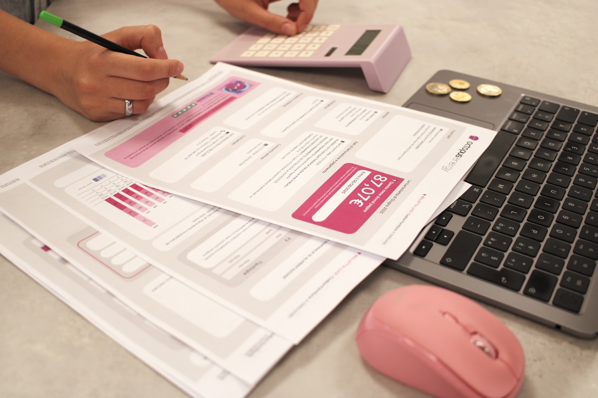 Calculating TDS deductions with a calculator and laptop
