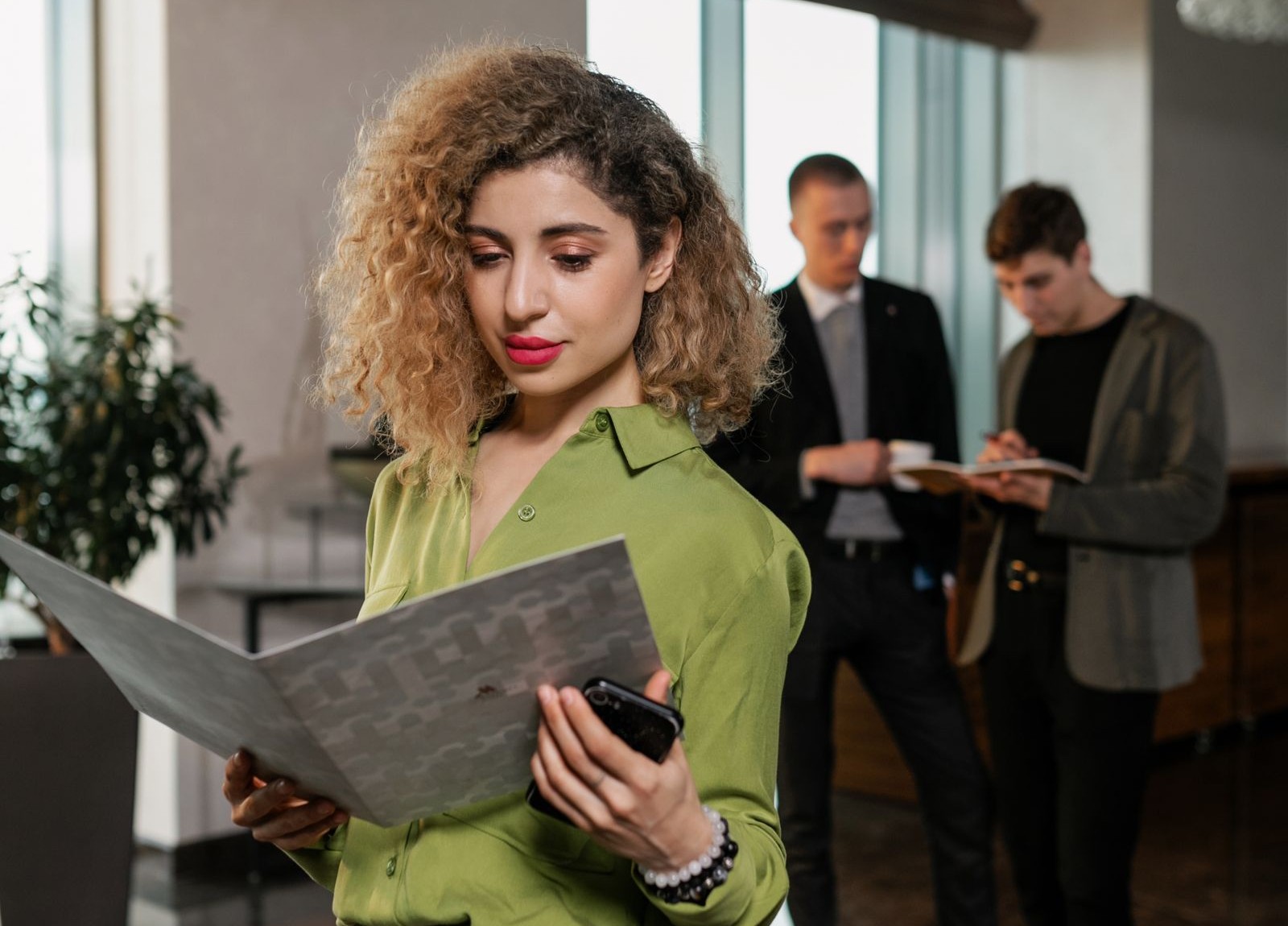 How Guests Can File Complaints Against Your Hotel 1 A hotel manager reviewing a formal notice about guest complaints against hotels at the front desk